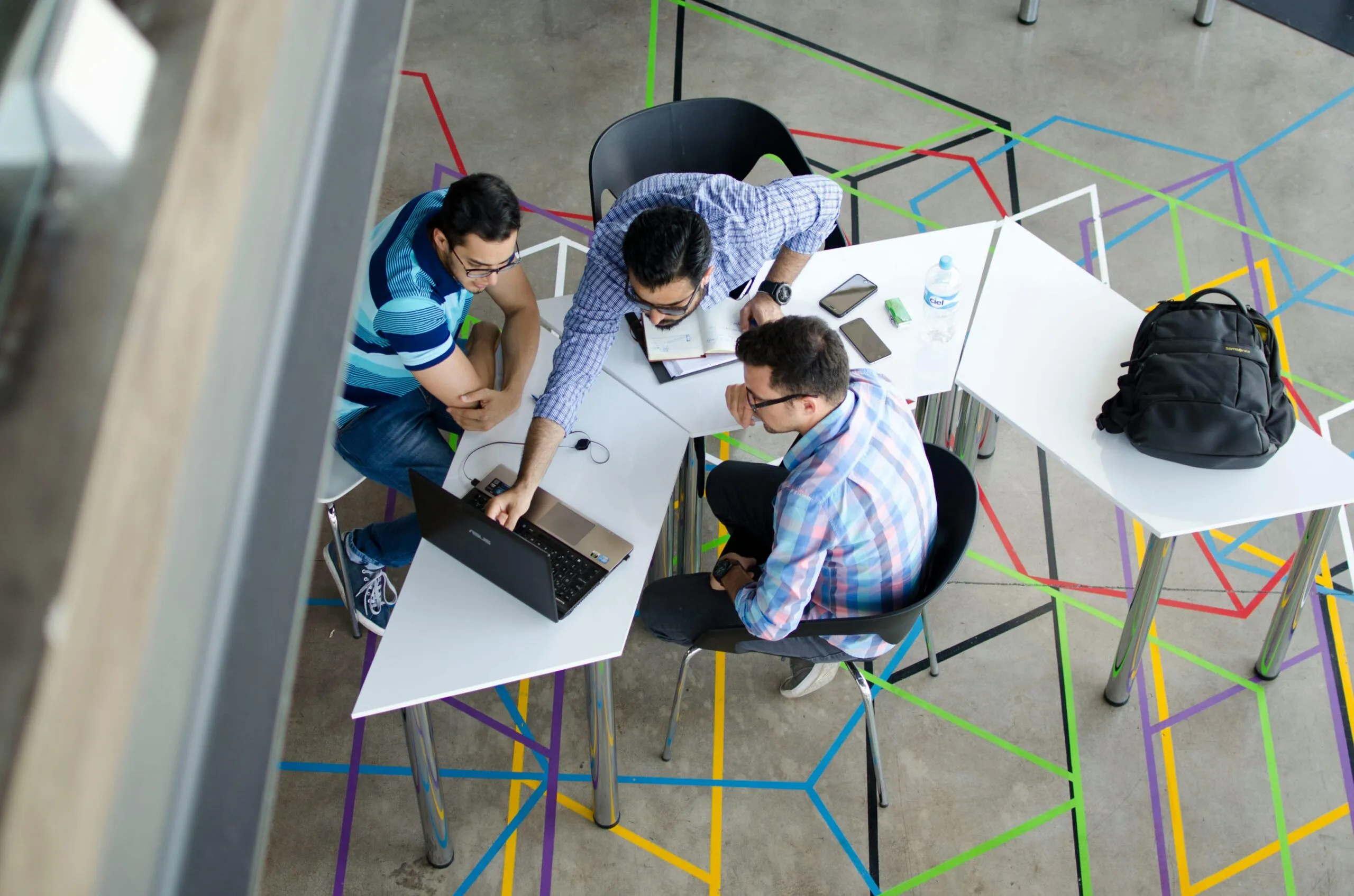 Overhead view of a team working together around a table